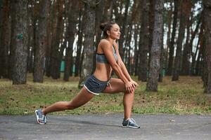 Young woman running outdoors in a city park photo