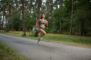 Young woman running outdoors in a city park photo