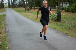 young athlete running in the forest photo