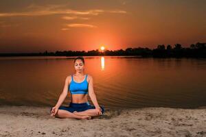 yoga at sunset on the beach. photo