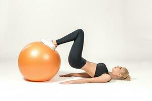 Young woman training with fitball photo