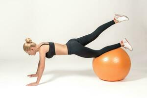 Young woman training with fitball photo