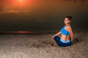 yoga at sunset on the beach. photo