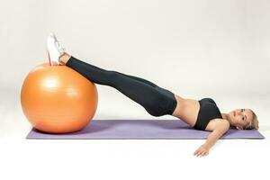 Young woman training with fitball photo