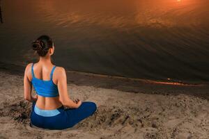 yoga at sunset on the beach. photo