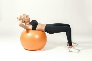 Young woman training with fitball photo