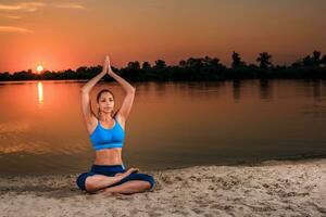 yoga at sunset on the beach. photo