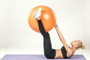 Young woman training with fitball photo