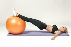 Young woman training with fitball photo