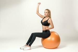 Young woman training with fitball photo