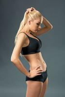 Young beautiful woman in fitness wear trained female body photo