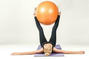 Young woman training with fitball photo