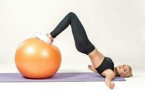 Young woman training with fitball photo