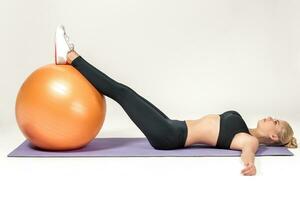 Young woman training with fitball photo