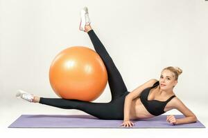 Young woman training with fitball photo