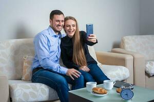 Beautiful young man and woman doing selfie with telephone camera photo