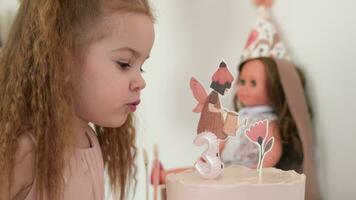 A little girl blows out a burning candle on a cake. Three years. video