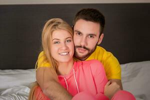 Young lovely couple lying and have fun in a bed photo