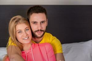 Young lovely couple have fun in a bed photo