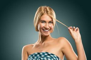 Portrait beautiful blond woman hand holding a strand of hair photo