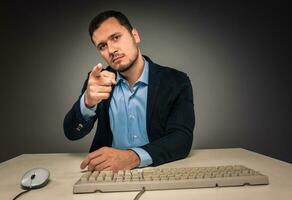 Man is gesturing with hand, pointing finger at camera photo