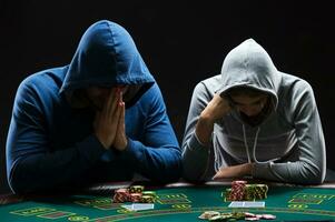 Two professional poker players sitting at a table photo