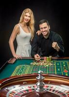 Couple playing roulette wins at the casino. photo