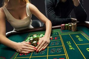 Couple playing roulette wins at the casino. photo