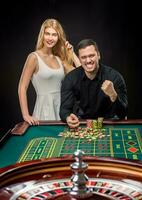 Couple playing roulette wins at the casino. photo