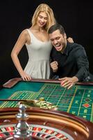 Couple playing roulette wins at the casino. photo