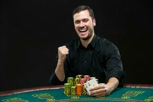 Happy poker player winning and holding a pair of aces photo
