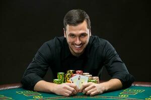 Happy poker player winning and holding a pair of aces photo