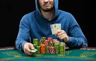 Poker player showing a pair of aces. Closeup photo
