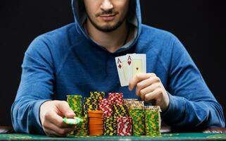 Poker player showing a pair of aces photo