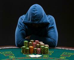 Portrait of a professional poker player sitting at pokers table photo