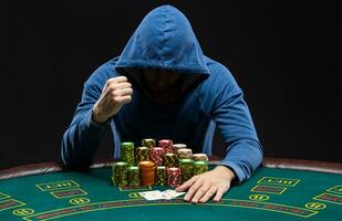 Portrait of a professional poker player sitting at pokers table photo