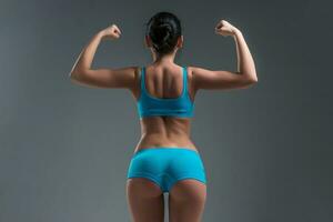 young athletic girl shows muscles photo