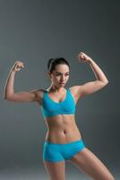 young athletic girl shows muscles photo