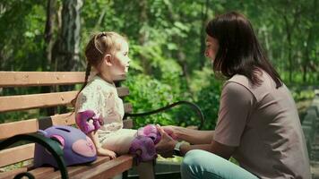 Mom puts protective equipment on her child before training. video