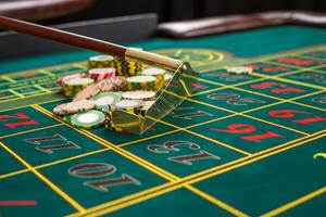Close up of gambling chips on green table in casino. photo