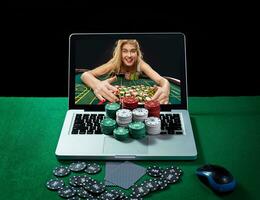 Green table with casino chips and cards on notebook photo