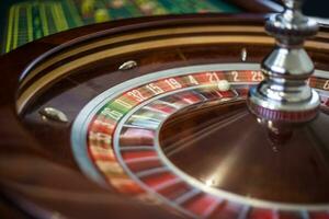 Casino roulette wheel with red sector twenty-one and ball. photo