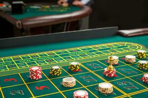 Picture of a green table and betting with chips. photo