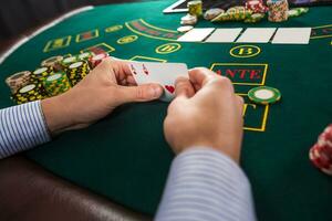 Male poker player holding the of two cards aces photo