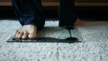 woman's feet on weight scale close up. video