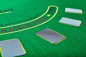 Playing cards on green table surface. Casino, gambling, poker concept photo