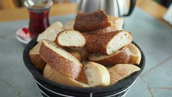 Turkish Bagel Simit in a bowl served with tea on table video