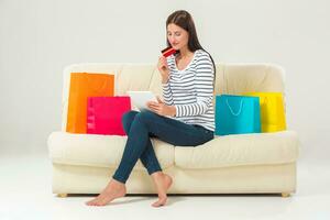 Online shopping. smiling young woman with tablet and credit card photo