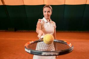 young sportswoman playing tennis photo