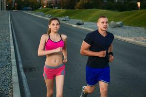 Close-up portrait of athletic couple running photo